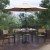 Flash Furniture XU-DG-304860064-UB19BTN-GG 30" x 48" Patio Dining Table, Tan Umbrella, Base & 4 Synthetic Teak Stackable Chairs, 7 Piece Set addl-1