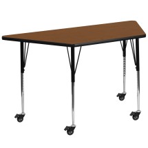 Flash Furniture XU-A3060-TRAP-OAK-H-A-CAS-GG Mobile 29''W x 57''L Trapezoid Oak Laminate Height Adjustable Activity Table